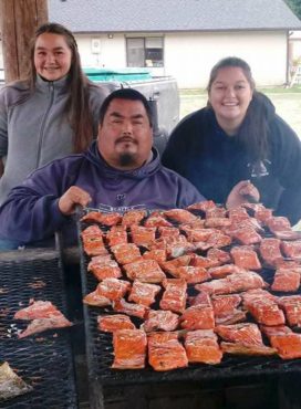 Port Gamble S'Klallam master fish cook Benji Ives with two of his four daughters, Lillian and Katamia. "They are learning all I know and they are very skilled," he said. (Photo courtesy Amanda Ives)