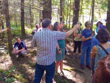 Kitsap County forester Arno Bergstrom shares forest management practices with trainees at Port Gamble Heritage Park.