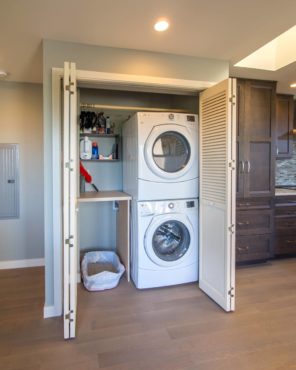 Laundry closet with hanging rod, folding counter, shelves and litter box (Photo courtesy A Kitchen That Works LLC)