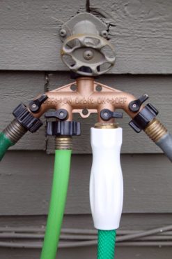 Hook up to four hoses to one bibb with an adapter. It makes watering easier — simply turn on the hose or hoses you want charged. Gardens change, and hoses provide more flexibility than fixed irrigation systems. (Photo courtesy Richard Walker)