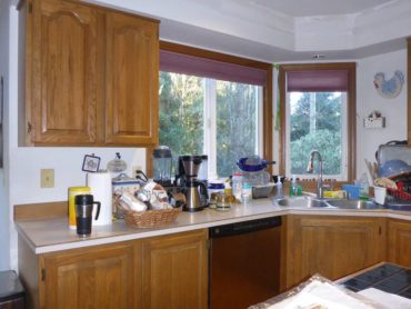 Red Oak-raised-panel-three-quarter-overlay, wall and base cabinet with center mullion and exposed hinges