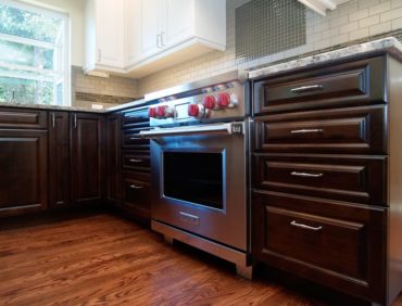 Frameless cabinets with full-overlay, raised- panel doors and drawers and light valance on wall cabinets