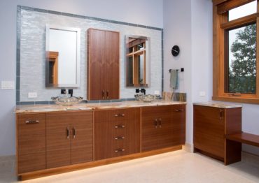 Contemporary, book-matched mahogany cabinets with slab doors and drawers