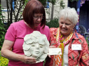 Barb Bourscheidt presents Lucy Hardiman with a thank-you gift for opening her private garden to the group.