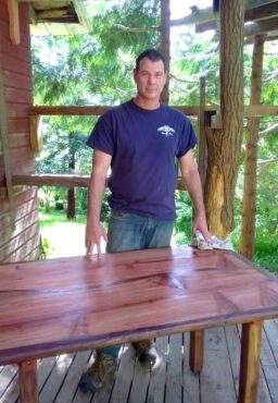 James Nybo puts the finishing touch on a new table.