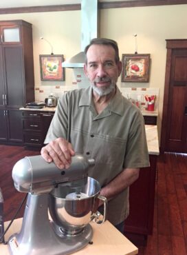 Jeff Stelmach uses a mixer to knead dough.