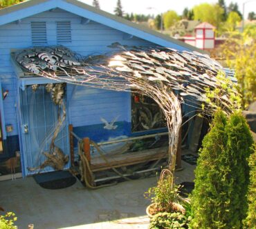 This "jungle trellis," made from stainless steel and bronze for a North Tacoma customer's carport roof patio, diverts rainwater and drains into a pool.