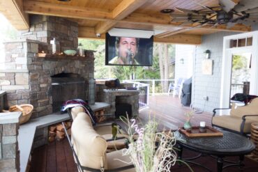 Outdoor entertainment area complete with a 65-inch, motorized, flip-down, high-definition screen and home-theater surround system.