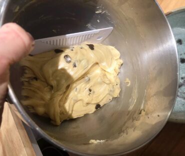 Scrape dough into a buttered bowl.