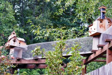 Fanciful birdhouses, created by Jim McIntyre, decorate the cat ramp that leads to the McIntyres’ cat enclosure. <em>(Photo courtesy Luba Fetterman)</em>