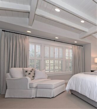 Pleated linen draperies paired with shutters