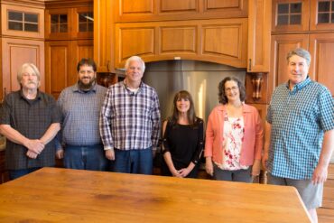 From left to right: Michael Scheurich, design/sales; Ben Muhleman, design/sales; Howie Hulst, design/sales; Cindy Friend, design/sales; Tess Moore, owner; Brad Moore, design/sales/owner