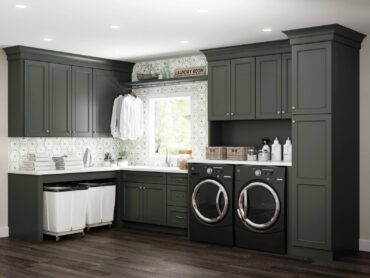 Rolling laundry baskets, wardrobe bar, storage cabinets and sink make this a high-functioning and organized laundry/mudroom. (Photo courtesy Dura Supreme Cabinetry)