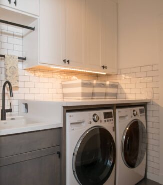 Access hole on left panel of washer allows the water lines to be disconnected without moving the machine. (Photo courtesey A Kitchen That Works LLC)