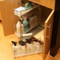 Keep cleaning products organized and mobile. (Photo courtesy Dura Supreme Cabinetry)