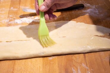 Fold dough over filling and brush wit egg white.