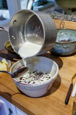 Add simmering cream to chocolate.