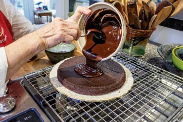 When glaze is shiny and smooth, pour over cake.