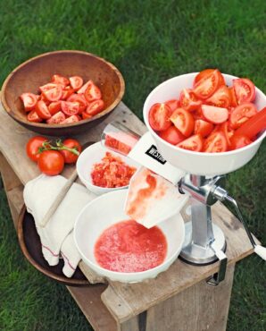 Tomato press and sauce makers turn garden-ripe tomatoes into seed-free, skin-free sauce with the turn of a handle. (Photo courtesy <a gref="https://www.gardeners.com">Gardener's Supply Company</a>)