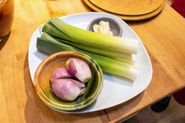 Fresh alliums complement the mushrooms.