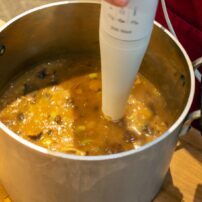 An immersion blender works well with hot soup.