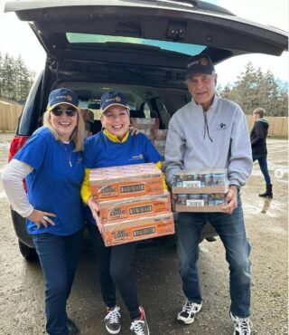 Lonna Calas, community service chair, with Midday Rotary volunteers Carol Virak and Dick Siler