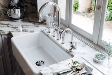 Perrin & Rowe deck-mounted, Armstrong bridge, dual-lever faucet, filter faucet and soap dispenser in polished nickel and farmhouse sink in white
