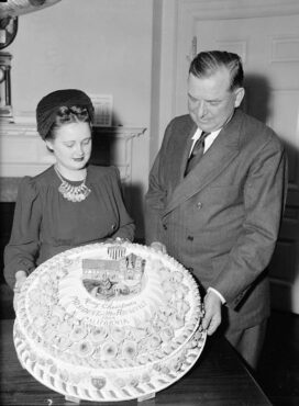 At the White House on Dec. 19, 1939, being accepted on behalf of President Roosevelt by Presidential Secretary Brig. Gen. Edwin Watson from Mildred Cook, secretary to Rep. A.J. Elliott of California. The cake was a gift from W.C. Baker of Ojai, California, who had baked cakes for the White House for the past 17 years.