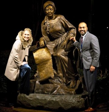 Mardie Rees and Deepak Devasthali, COO of Saint Anne Hospital in Burien, Wash. with Saint Anne in bronze after the unveiling. (Photo courtesy David Rinker)