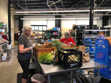 Fishline volunteers glean vegetable donations to prepare for distribution in the market.