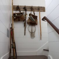 Tom Jones’ father made this driftwood wall rack to store fishing gear. Now it’s used to display vintage fishing gear that belonged to the couple’s grandparents.