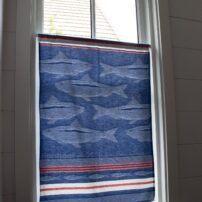 One of Christie Jones’ favorite places to discover French tea towels is Watson Kennedy in Seattle. She repurposed her collection by making curtains for various windows throughout the cottages. Fish are a common theme in the prints she collects, which flow well with their home’s theme of water.