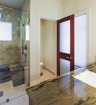 Water closet with sapele door with obscure glass to match the sapele cabinetry