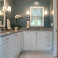 Wall sconces with an overhead can light provide good illumination for grooming. (Photo courtesy McCabe By Design)