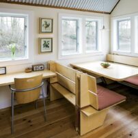 Floating ADU interior — dining and desk