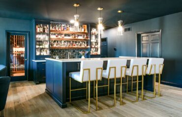 Fully stocked “glam” bar with back wall and bartop island (wine cellar behind the bar back wall) by Ashleigh Schroeder of NEST Kitchen, Bath & Home Design LLC (Photo courtesy Suzy Gorman)