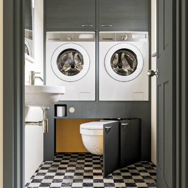 A beautifully designed laundry room/ powder room combination in a small space made possible with Hidealoo pivoting toilet mounting hardware (toilet not included)