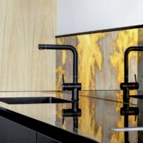Arcobaleno backsplash by Antique Mirror S.R.L creates a dramatic effect. Photography by Celeste Najt — Design by Jall&Tofta