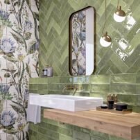 Porcelain Cinque Terre subway tiles with a gloss finish in emerald pairs brilliantly with botanical 8-inch by 8-inch porcelain field tiles from the Murales Optym collection by Mainzu Ceramica.