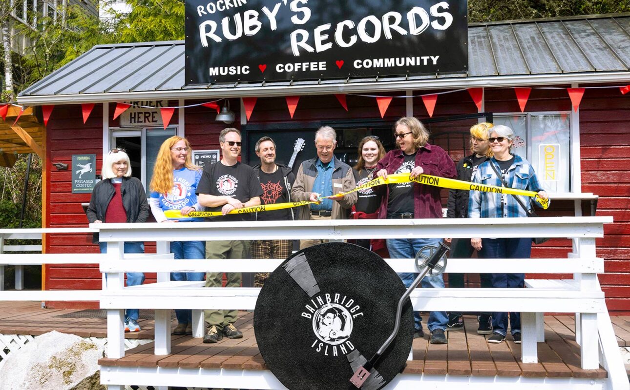 Bainbridge Island Deputy Mayor Jon Quitslund cuts the “ribbon” opening the new store alongside Rockin’ Ruby’s owners Melanie Peters, Jill Paisley, Stefan Goldby and Christine Goldby.