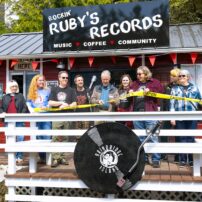 Bainbridge Island Deputy Mayor Jon Quitslund cuts the “ribbon” opening the new store alongside Rockin’ Ruby’s owners Melanie Peters, Jill Paisley, Stefan Goldby and Christine Goldby.