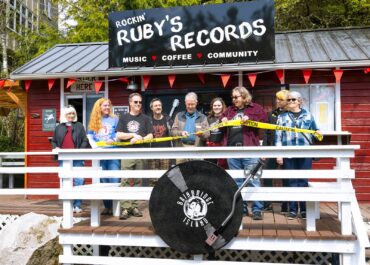 Bainbridge Island Deputy Mayor Jon Quitslund cuts the “ribbon” opening the new store alongside Rockin’ Ruby’s owners Melanie Peters, Jill Paisley, Stefan Goldby and Christine Goldby.