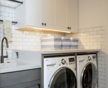 Undercabinet lighting in a laundry room is a cost-effective feature for making household tasks more pleasurable. Design by McCabe By Design LLC