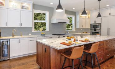 48-inch exhaust mantle-style hood over three Gaggenau Vario cooktops — electric grill, propane-induction. Design by McCabe By Design LLC (Photography courtesy Keith Brofsky)