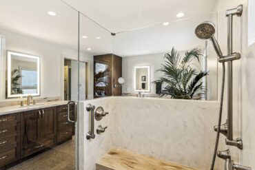 Solid-surface shower surround and vanity tops. Design by McCabe By Design LLC (Photography courtesy Tammy Dwight)