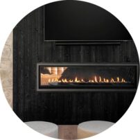 BEAUTY AND WARMTH: The fireplace is Fireplace Xtrordinair ProBuilder 72 Deluxe installed by Wallace Fireplace. The wall is Montana Timber Products AquaFir in Black.
