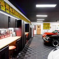 FLOOR IT: The flooring is RaceDeck free-flow black flooring with a gray perimeter. "This is the second home I have done this floor in, and I love it. It is indestructible. It drains so the garage is always fine to walk around in socks, and it is about a quarter of the price of epoxy. I installed it myself in about three hours wearing a sling after a shoulder surgery. It could not be easier."