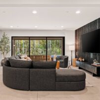 The floors are made of durable polished concrete in the bonus room area, the hall, and two bedrooms.