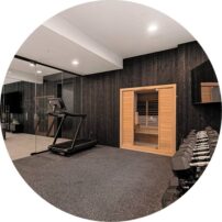 HOME GYM AND SAUNA The gym features Roppe Recoil light gray flooring. The sauna is by Sunlighten and is the Amplify Full Spectrum Sauna. City Glass installed the mirrors and the shower glass.