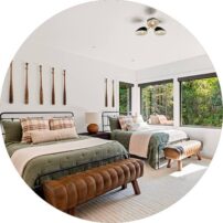 BATTER’S UP We love how Sage staged the furniture in this bedroom with vintage baseball bats on the wall for unique decor any kiddos would love.